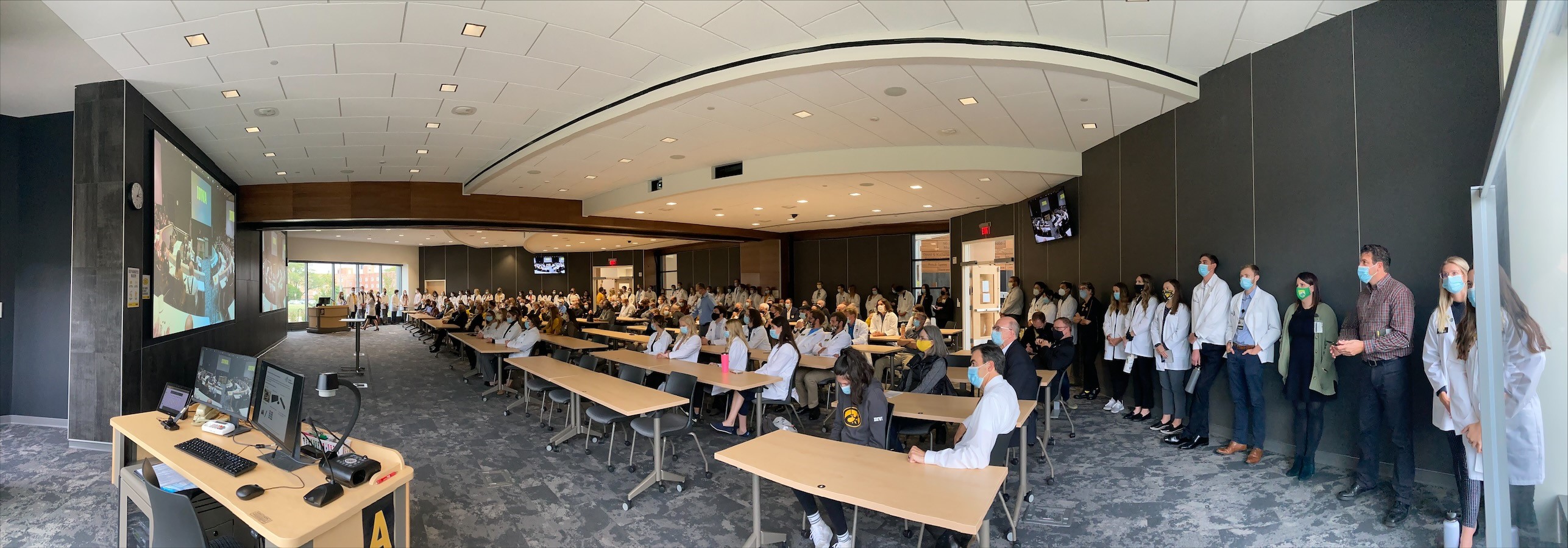 Participants at the 2021 UI College of Pharmacy Building dedication in the large overflow classroom.