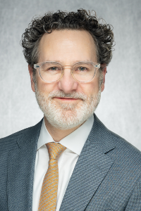 Headshot from the chest up of Mark Greiner.