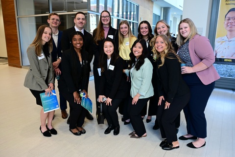 Photo of pharmacy students posing in the college of pharmacy building lobby.