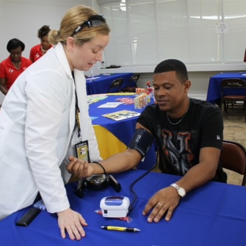 Jeanine Abrons checks a patient's blood pressure during a health clinic.
