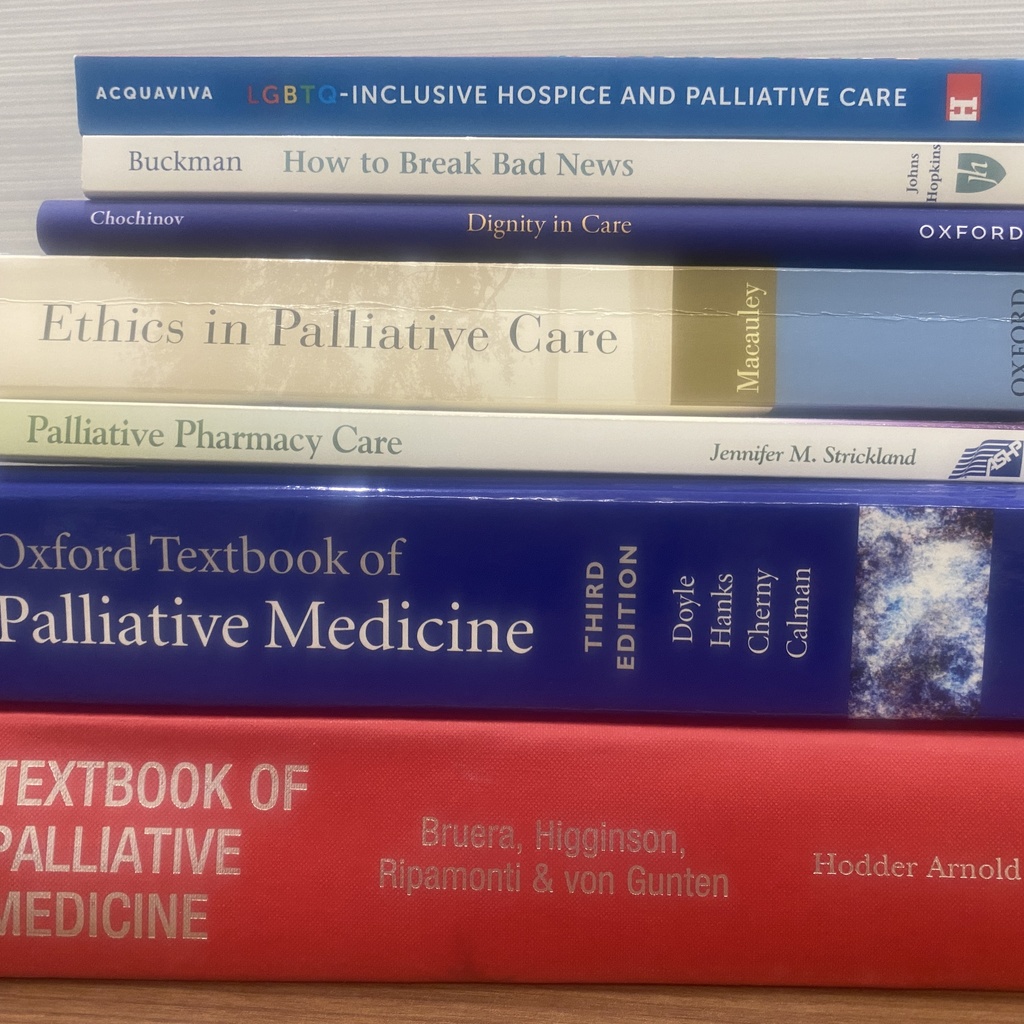 Stack of College of Pharmacy Palliative Care Text Books Closer