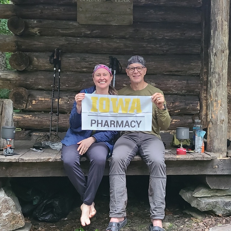 UI College of Pharmacy professors Korey Kennelty and Jeff Reist in front of a cabin following a hike.