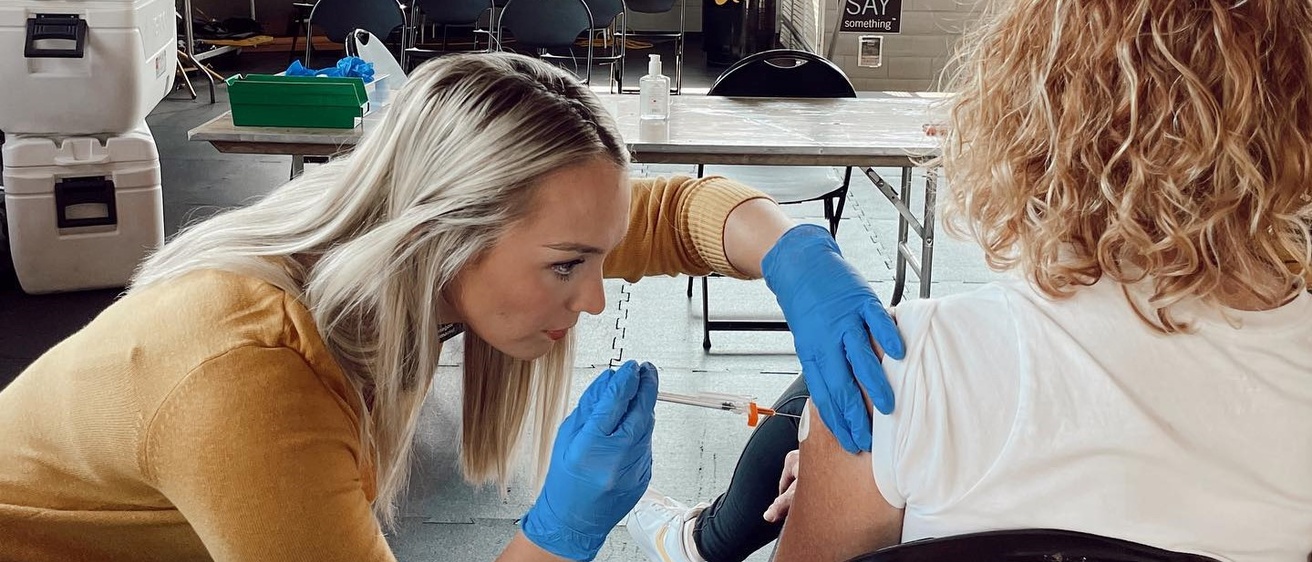 UI College of Pharmacy student giving a flu shot 2022.