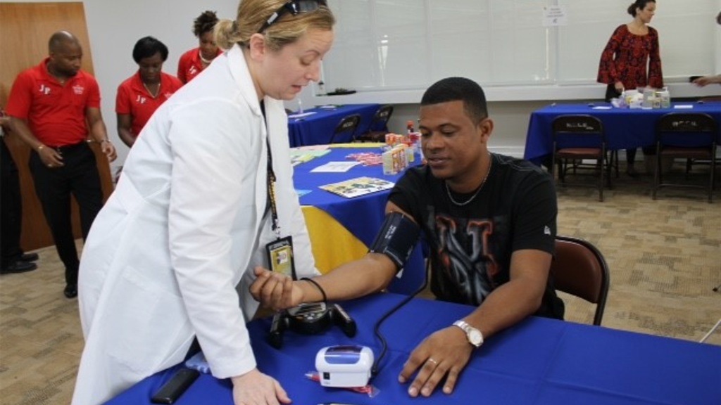 Jeanine Abrons checks a patient's blood pressure during a health clinic.