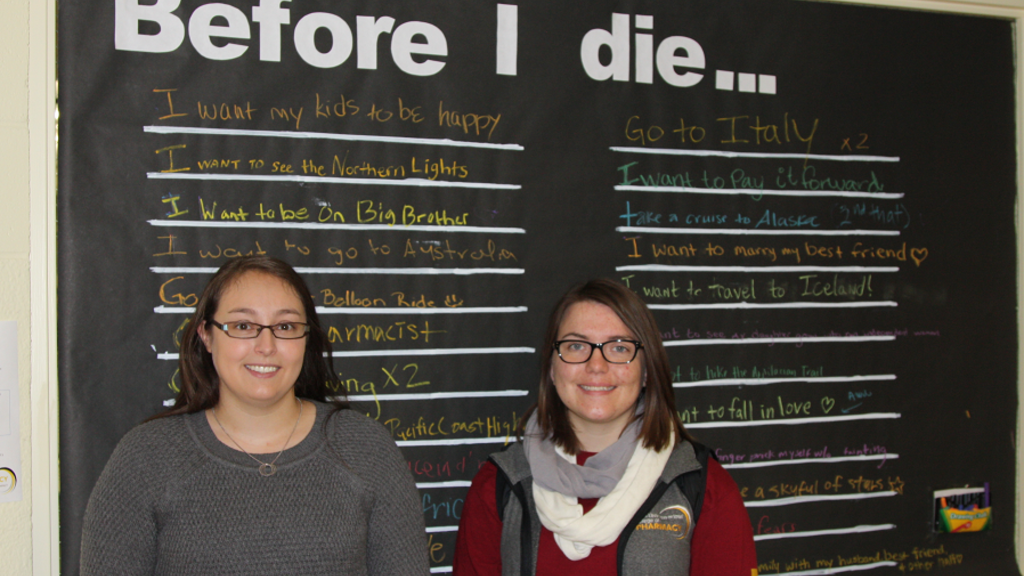 morgan jacks and sophia johnson stand in front of the Before I Die large paper