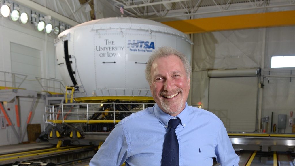 Gary Milavetz stands in front of the simulator.