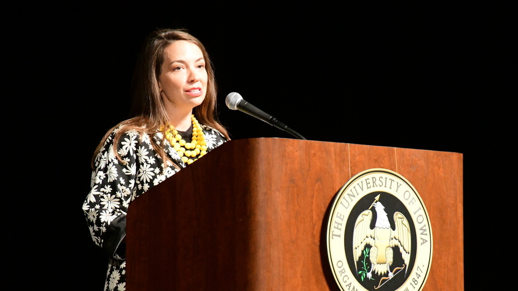 Susan Vos Speaking at Podium